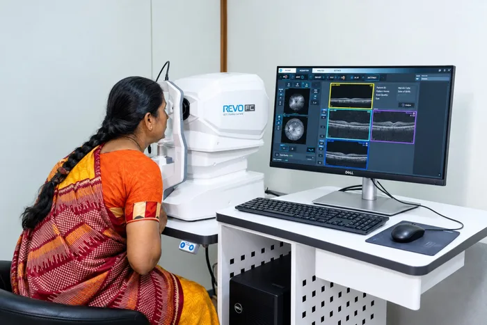Patient seated undergoing non-invasive optical coherence tomography examination