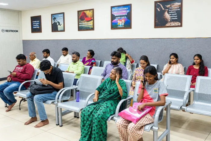 Spacious patient outpatient waiting lounge with ergonomic seating and health guidance displays
