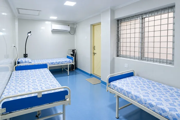 Sterile day-care patient recovery ward with clinical beds and air conditioning at Vijaya Eye Hospital